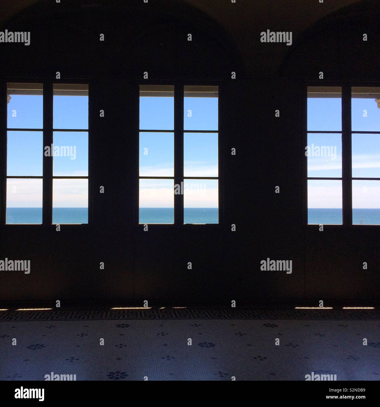 Windows overlooking the ocean on the second floor of The Breakers mansion, Newport, Rhode Island, United States - Smartphone Captured Stock Image