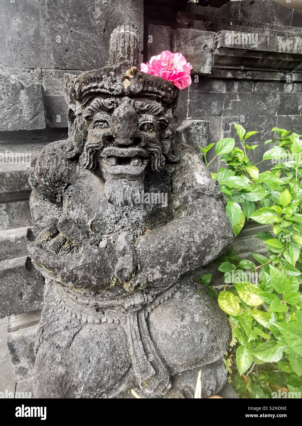 A sculpture of a Balinese guardian at a Balinese Hindu temple in Bali. - Smartphone Captured Stock Image