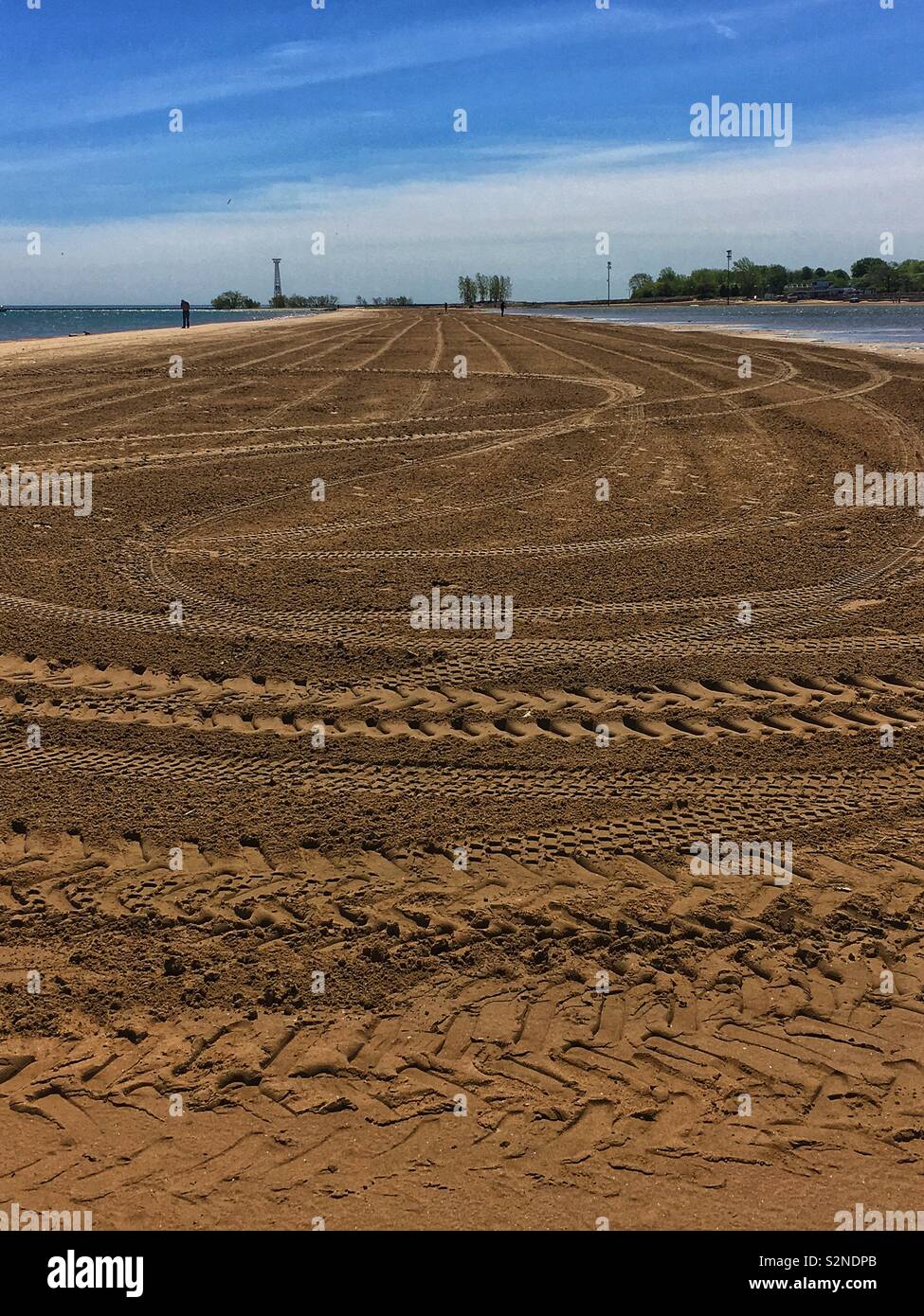 Freshly tilled sand beach on Montrose Harbor in Chicago, Illinois getting ready for the summer season. - Smartphone Captured Stock Image