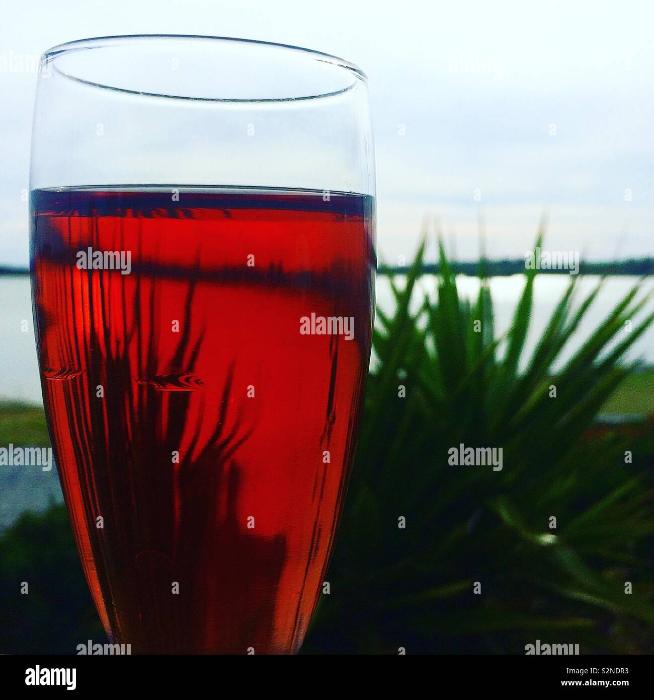 An aperitif of kir by a French lake Stock Photo