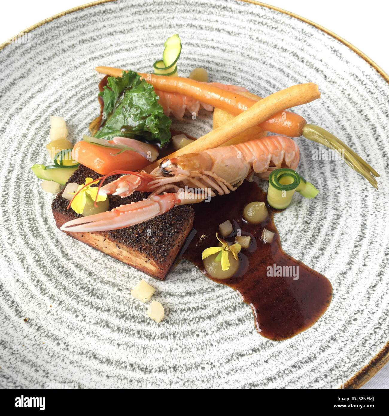 Pork belly & langoustine with Granny Smith apple and crackling - Smartphone Captured Stock Image