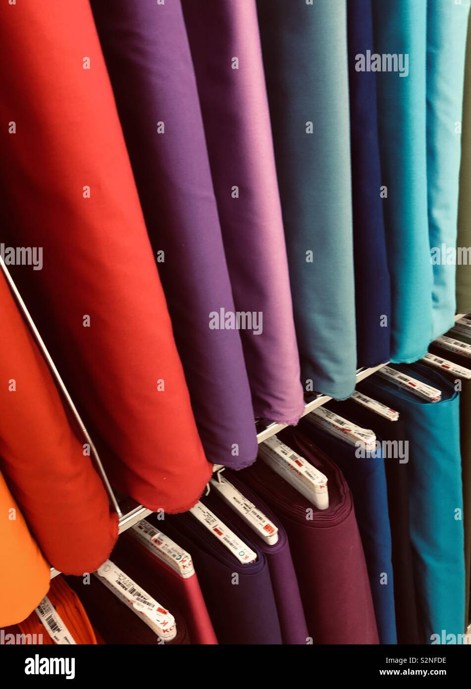 Bolts of fabric ready for endless possibilities of creative sewing projects Stock Photo