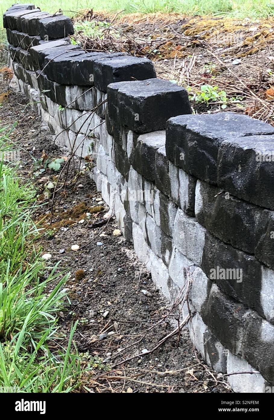 Crooked, wet, stone wall Stock Photo - Alamy