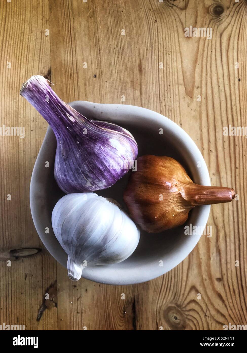 3 garlic bulbs in a pot - Smartphone Captured Stock Image