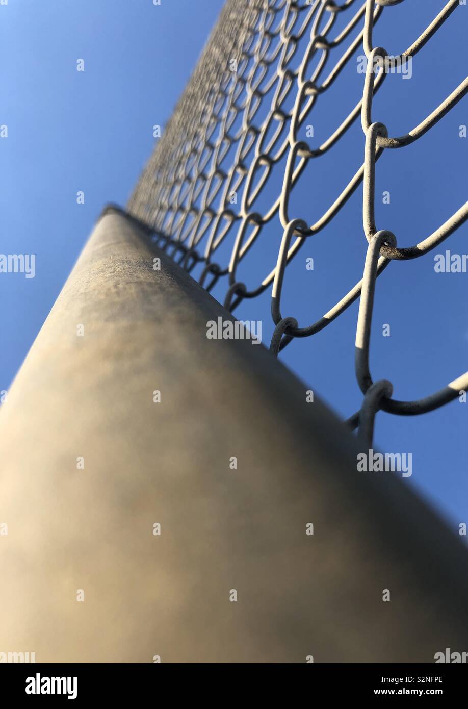 Looking at a mesh fence from below.  Close up Stock Photo