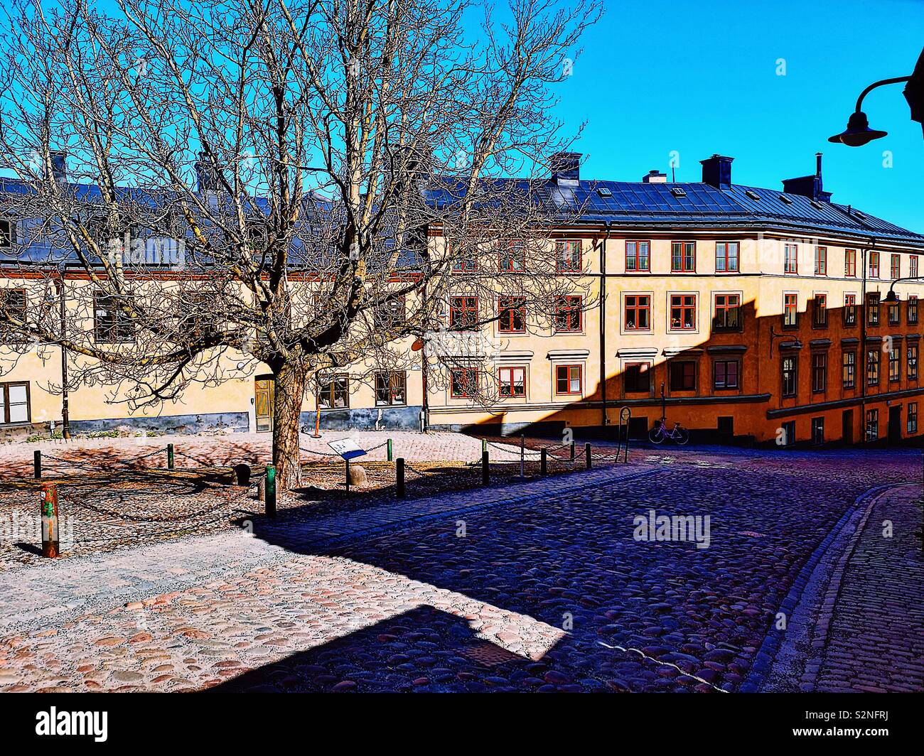Small triangular cobbled Square where Bastugatan meets Pryssgrand, Sodermalm, Stockholm, Sweden, Scandinavia. Well preserved 18th century houses - Smartphone Captured Stock Image