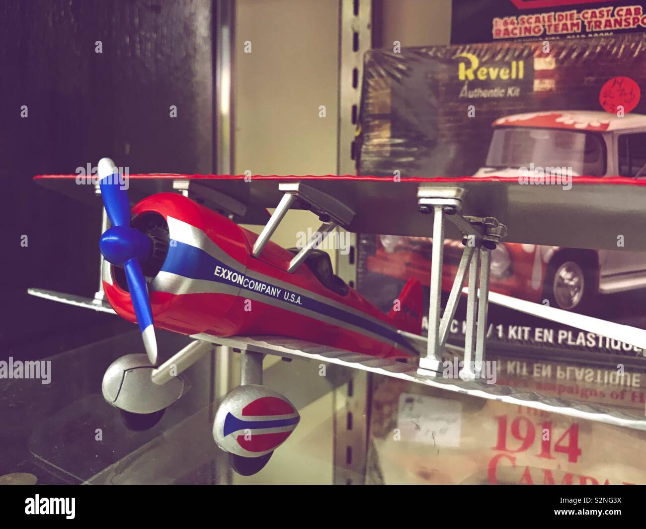 Bright red and blue model airplane on display in flea mall - Smartphone Captured Stock Image