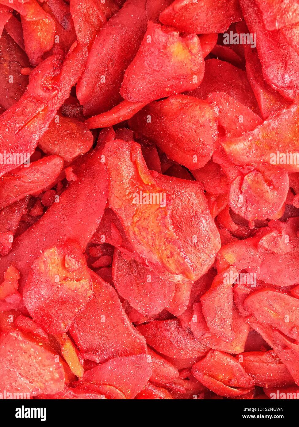 Full frame of dried mango slices covered in Chile powder as a popular