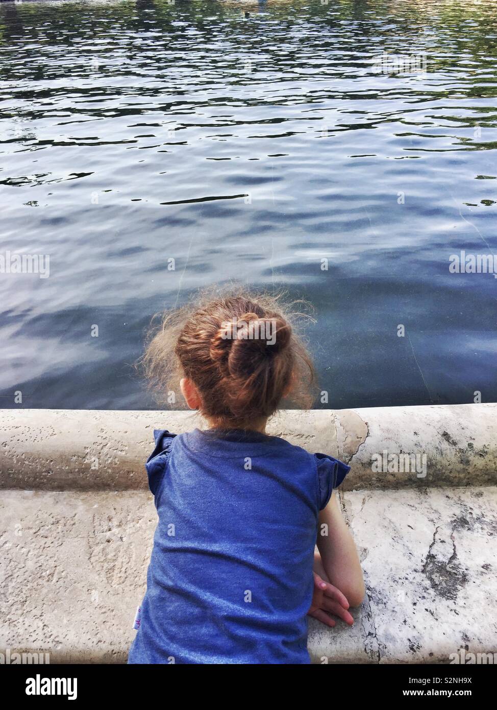 Little girl looking at water Stock Photo