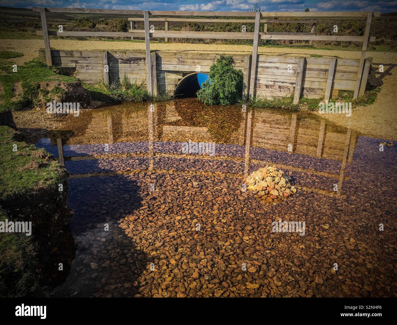 A clear pool by a foot bridge at Godshill in the New Forest - Smartphone Captured Stock Image