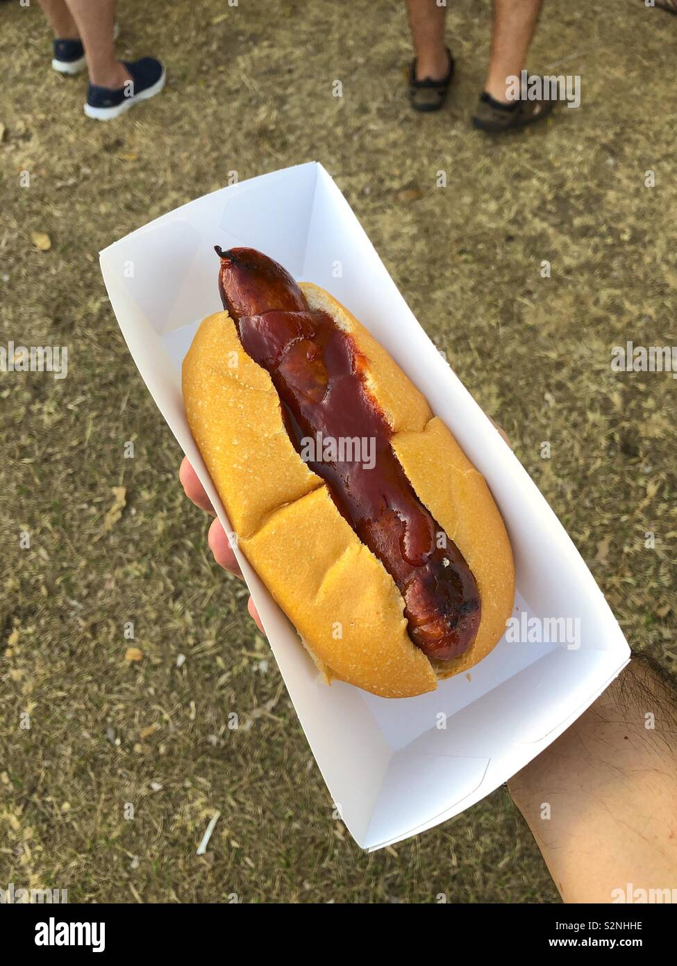 Chorizo sausage with tomato sauce in a bread roll. - Smartphone Captured Stock Image