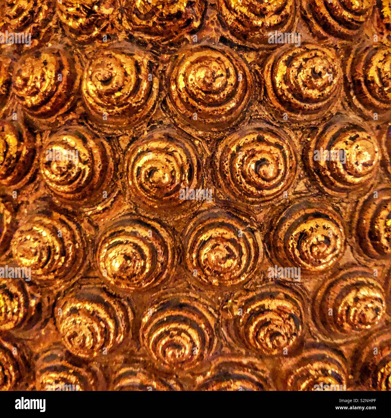 An abstract pattern of golden pointed spirals Stock Photo