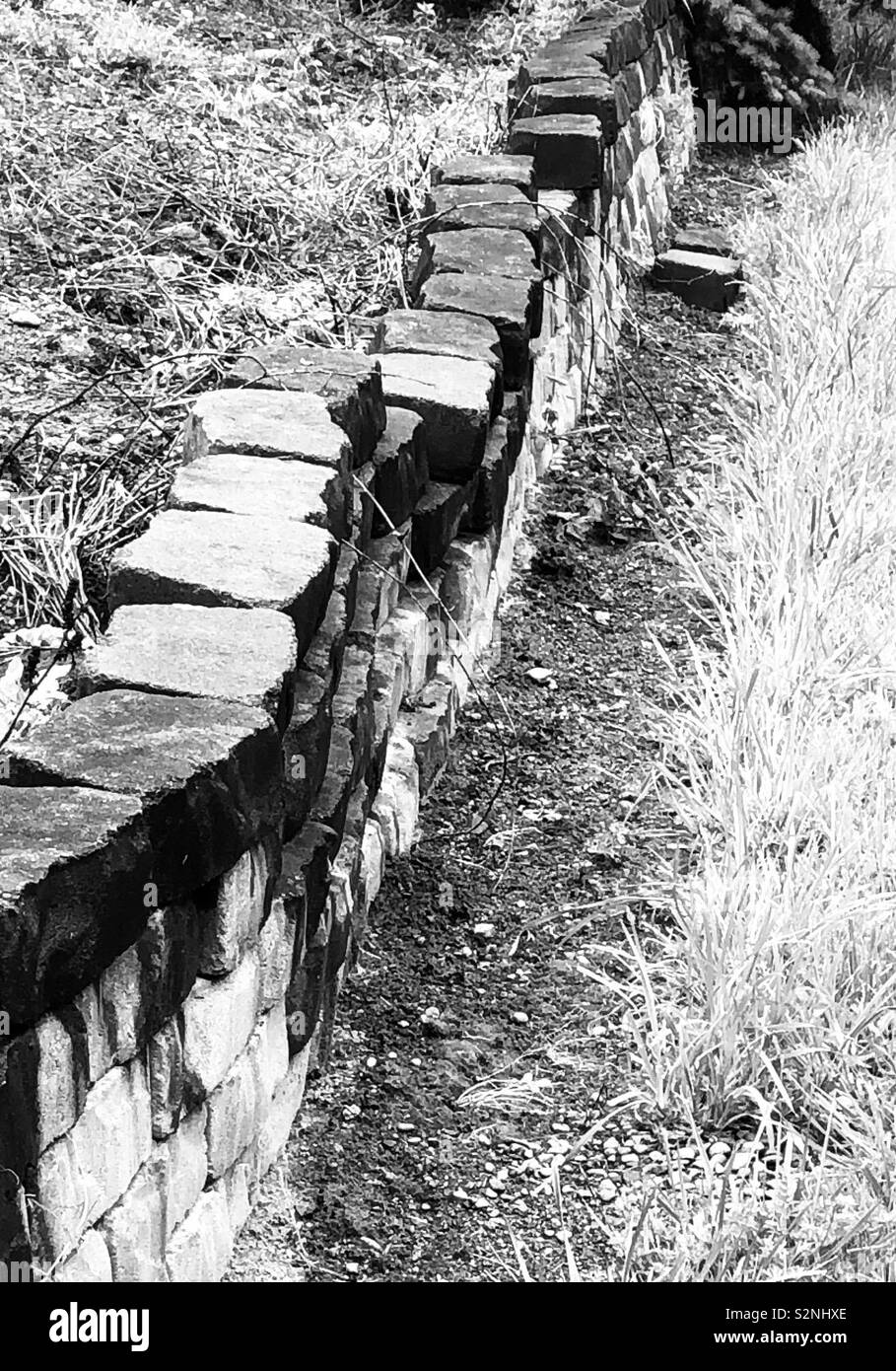 Crooked stone wall in black and white Stock Photo - Alamy