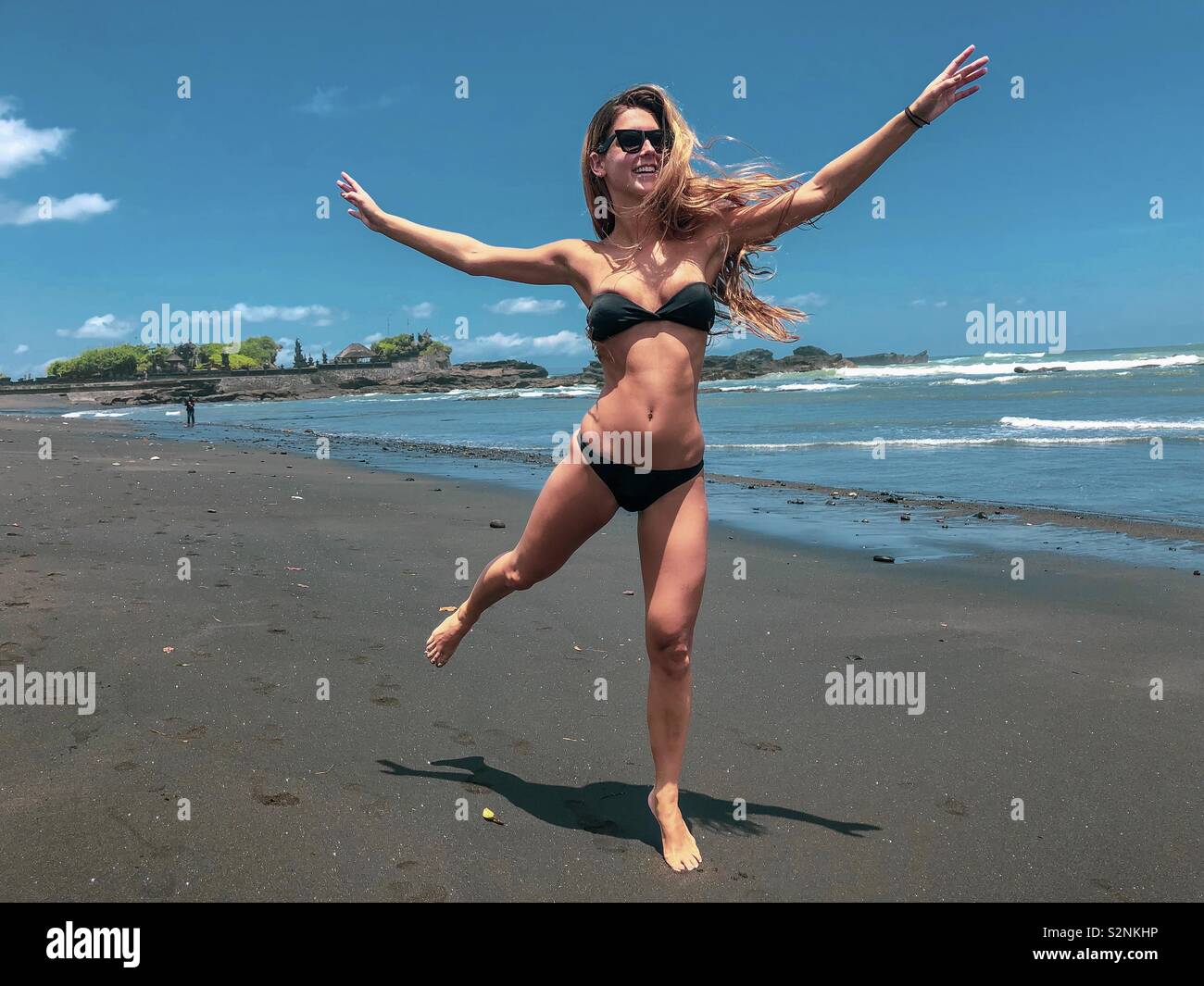 Girl jumping beach bikini hi-res stock photography and images - Alamy