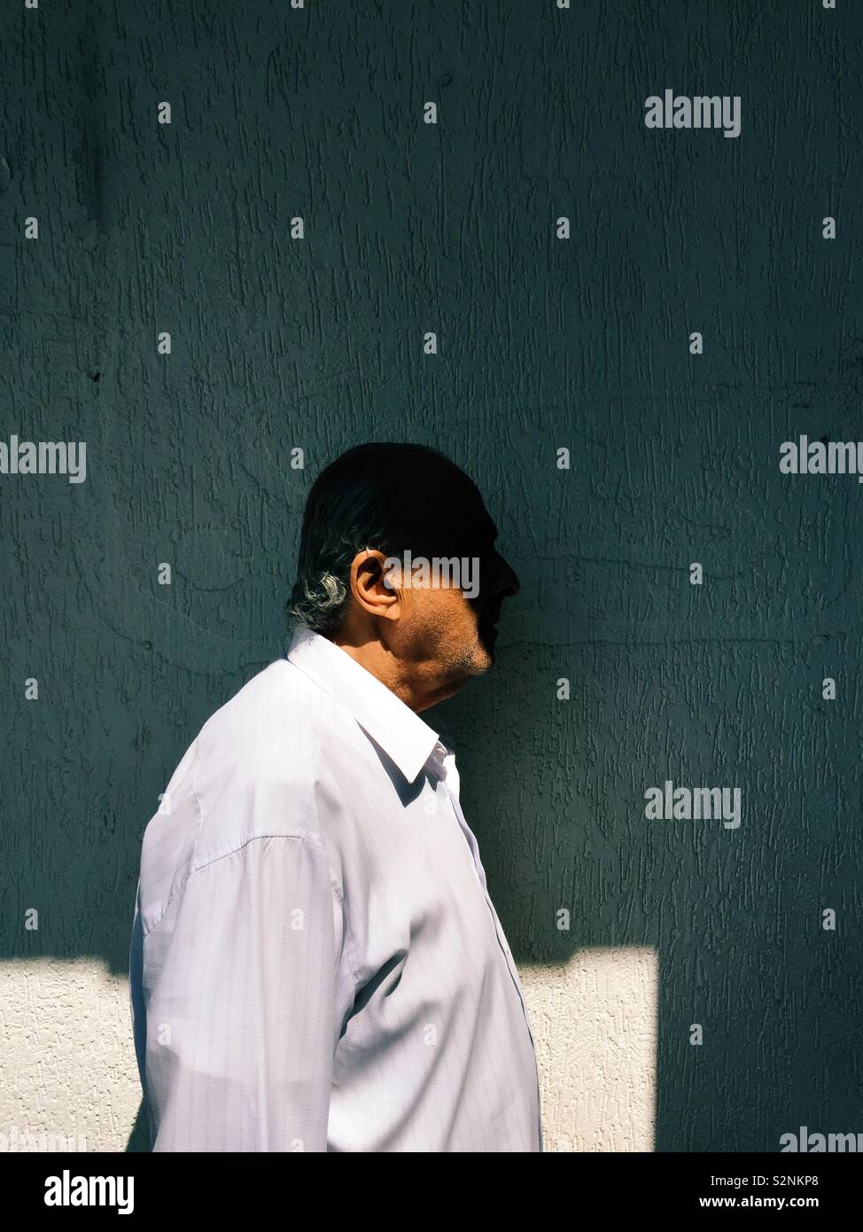 Side view of elderly man in the shade - Smartphone Captured Stock Image