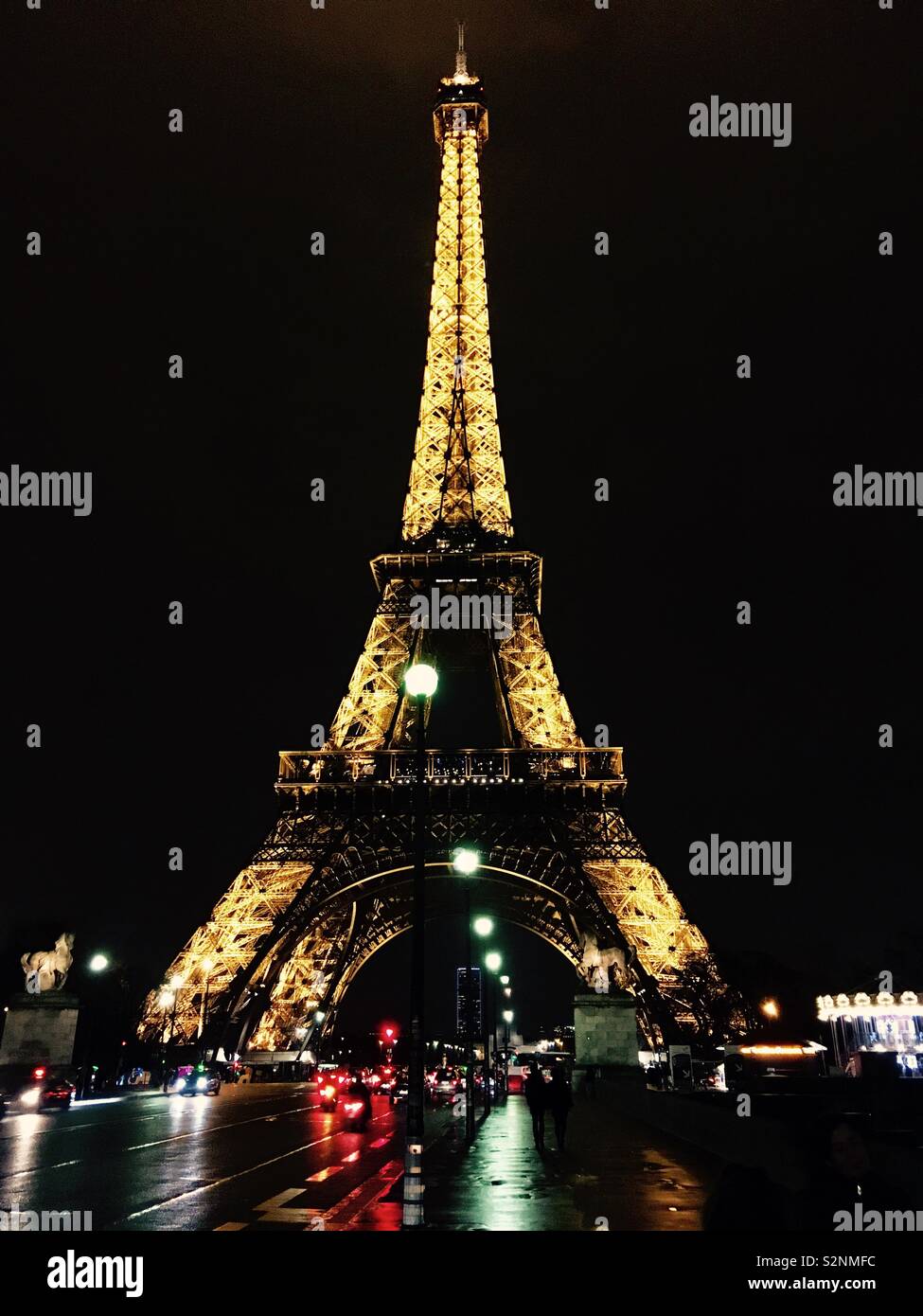Eiffel Tower lighted up in a rainy night Stock Photo