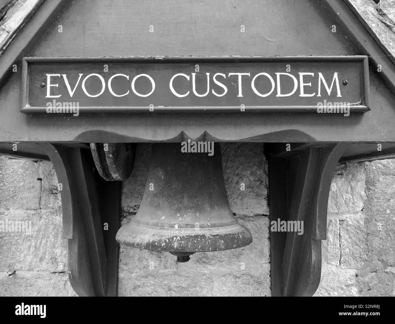 An unusual bell with a Latin Label saying Evoco Custodum or ‘Summon the Custodian’ at Snowshill Manor. Stock Photo