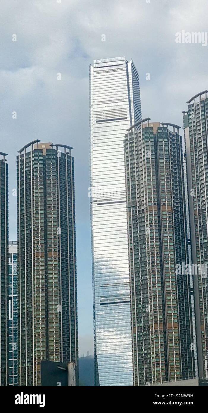 Icc tower between residential buildings in Kowloon, Hong Kong. - Smartphone Captured Stock Image