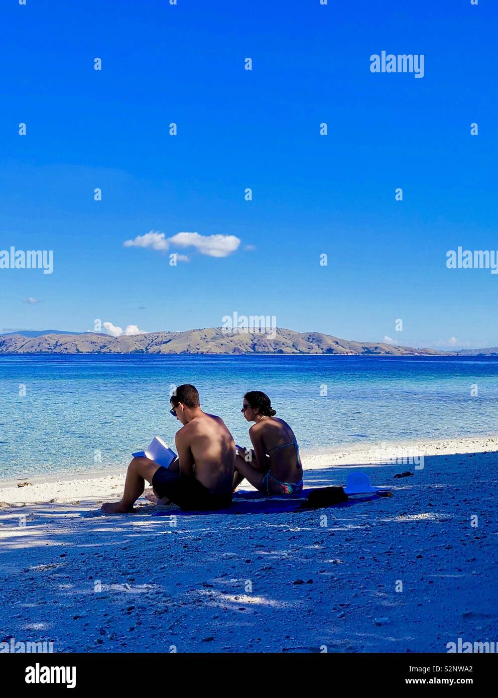 A couple enjoying a pristine beach in Komodo national park. - Smartphone Captured Stock Image