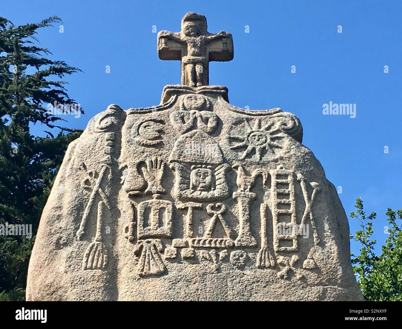 Christian carvings on Th megalithic Menhir of saint Uzec  Brittany, France Stock Photo