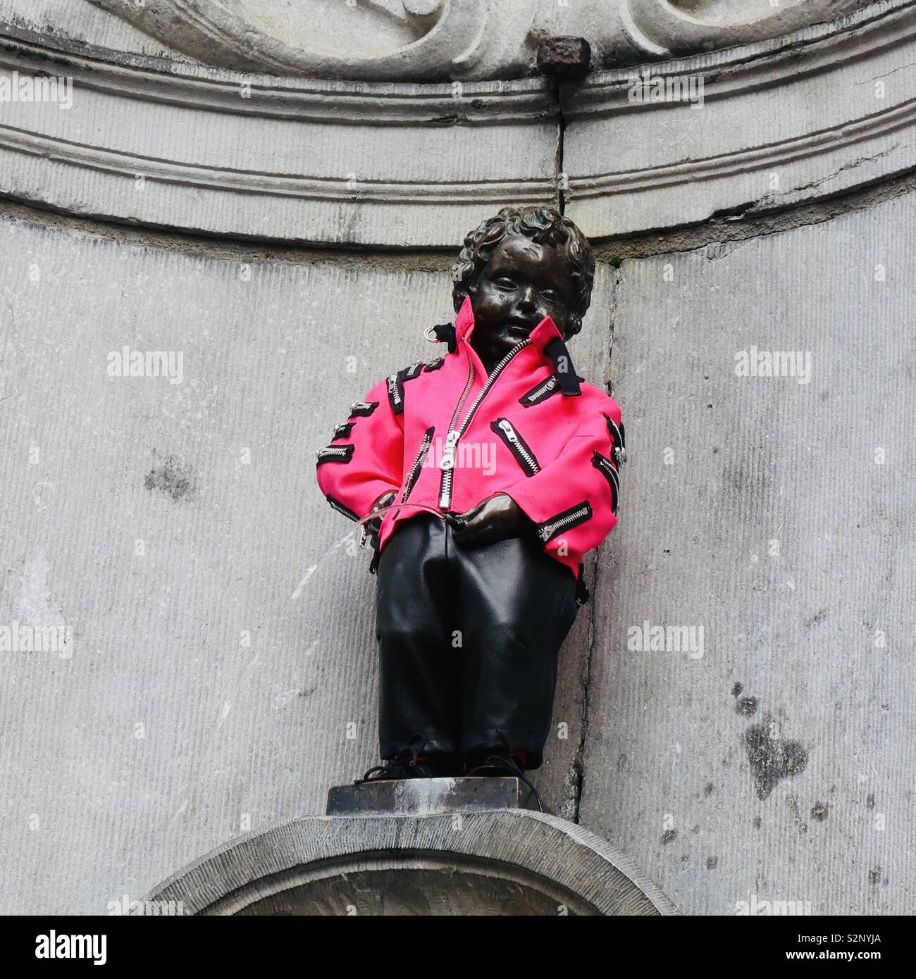 Brussels, Belgium - 29 May 2019: Mannekin Pis in a bright pink jacket. - Smartphone Captured Stock Image