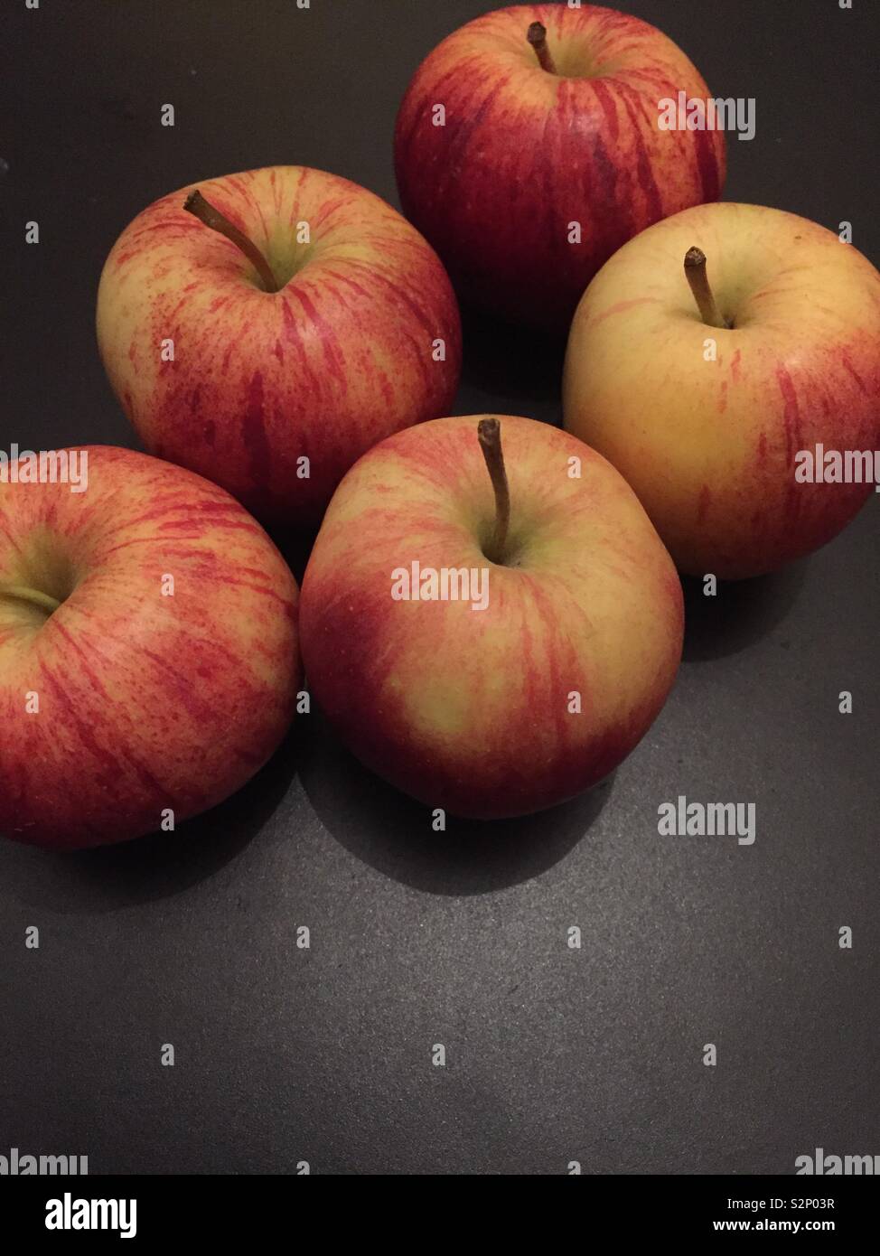 Braeburn red apples on black background - Smartphone Captured Stock Image