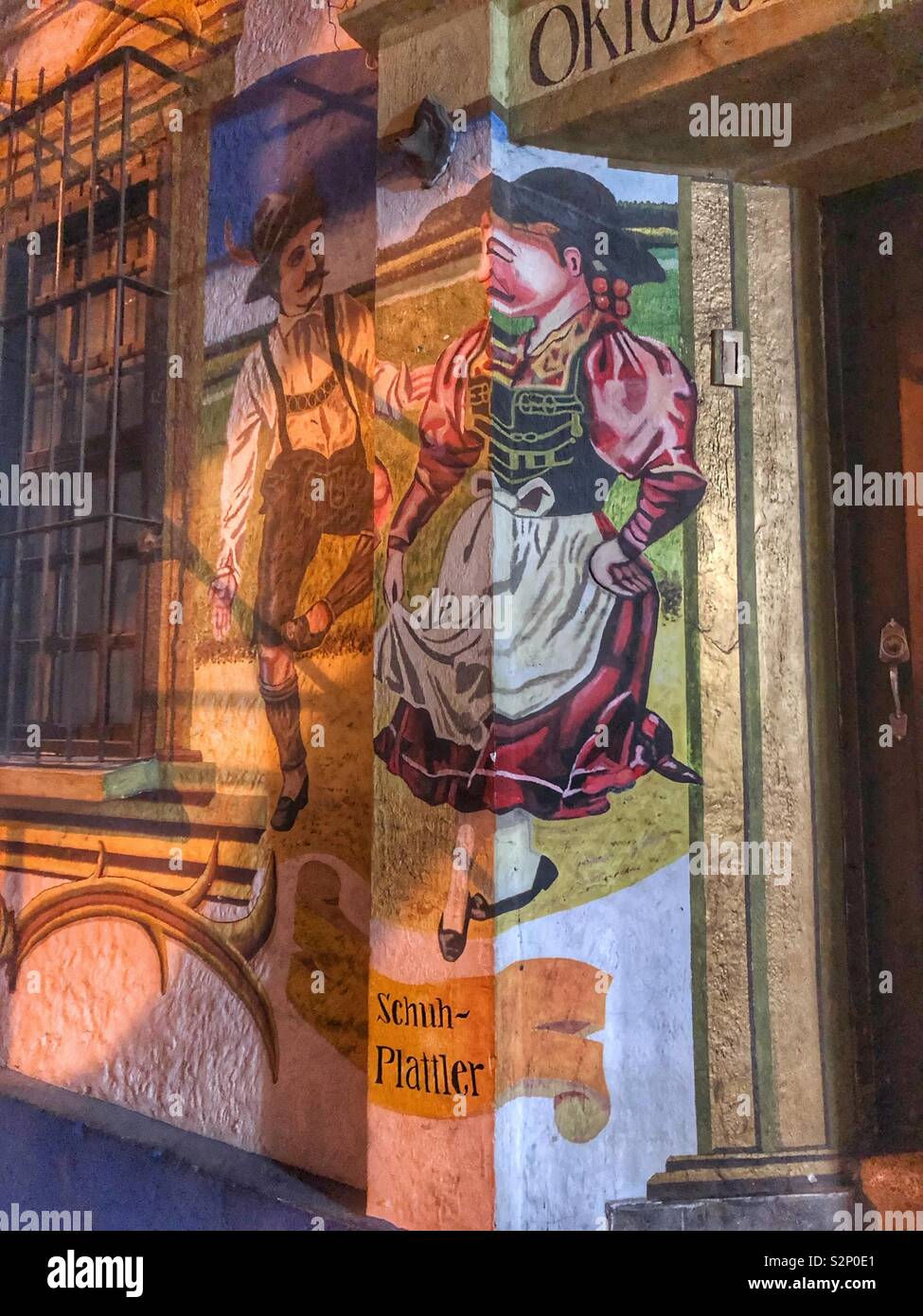 A painted mural on the exterior of a German restaurant. - Smartphone Captured Stock Image