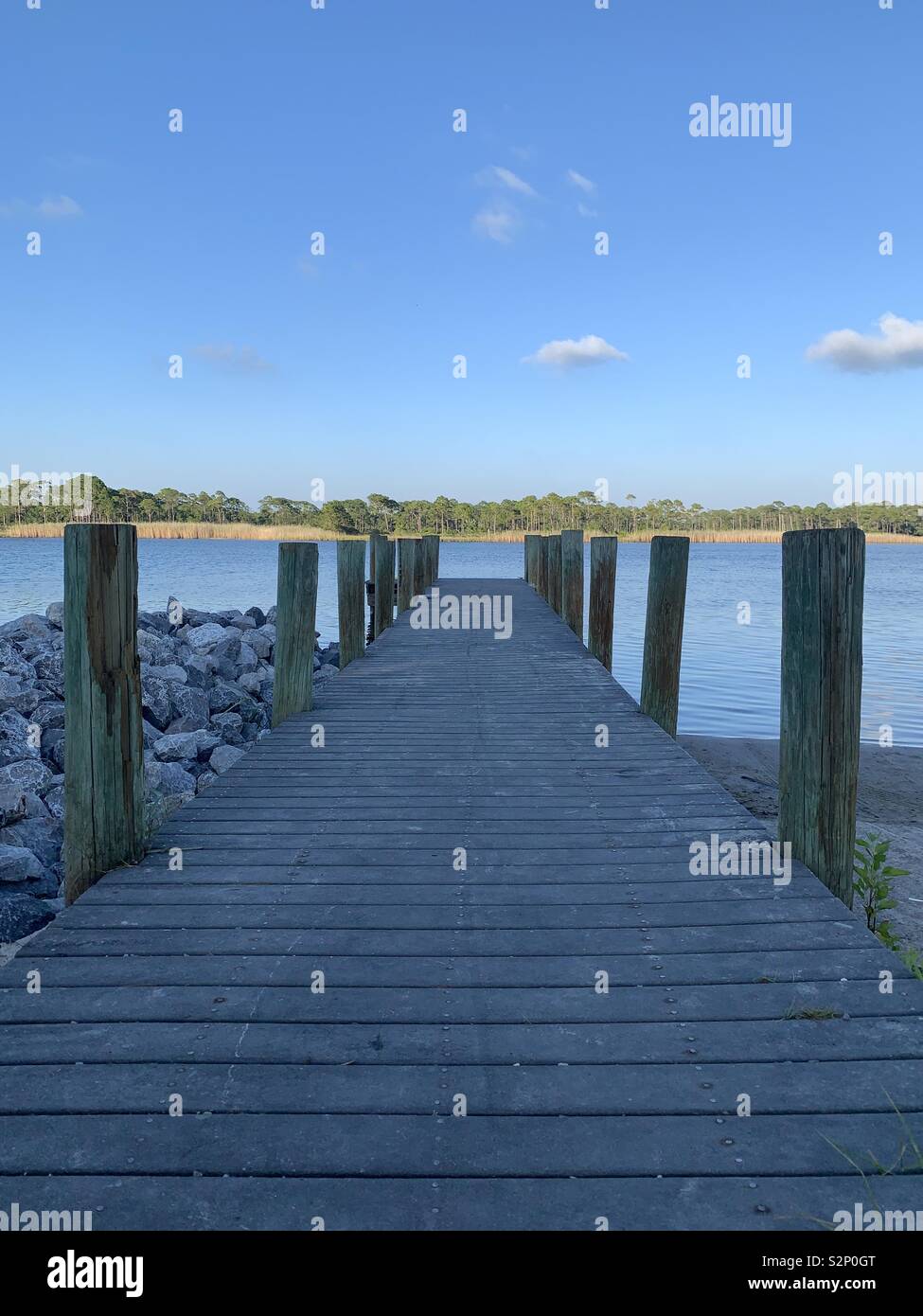 Pier leading to lake, Florida, scenic with blue skies and blue water - Smartphone Captured Stock Image