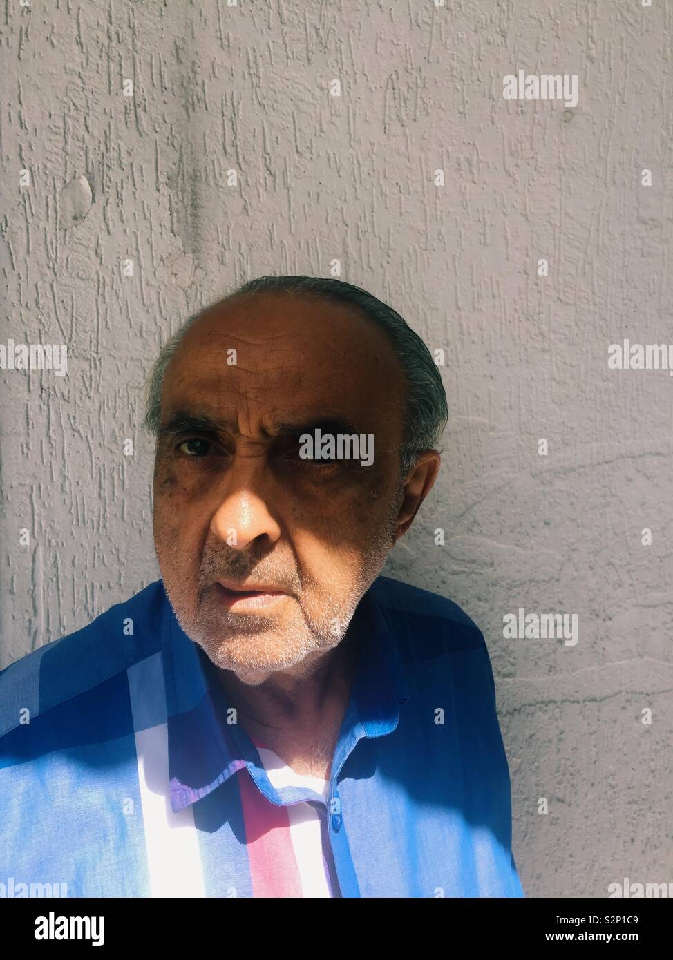 Serious man looking at camera - Smartphone Captured Stock Image