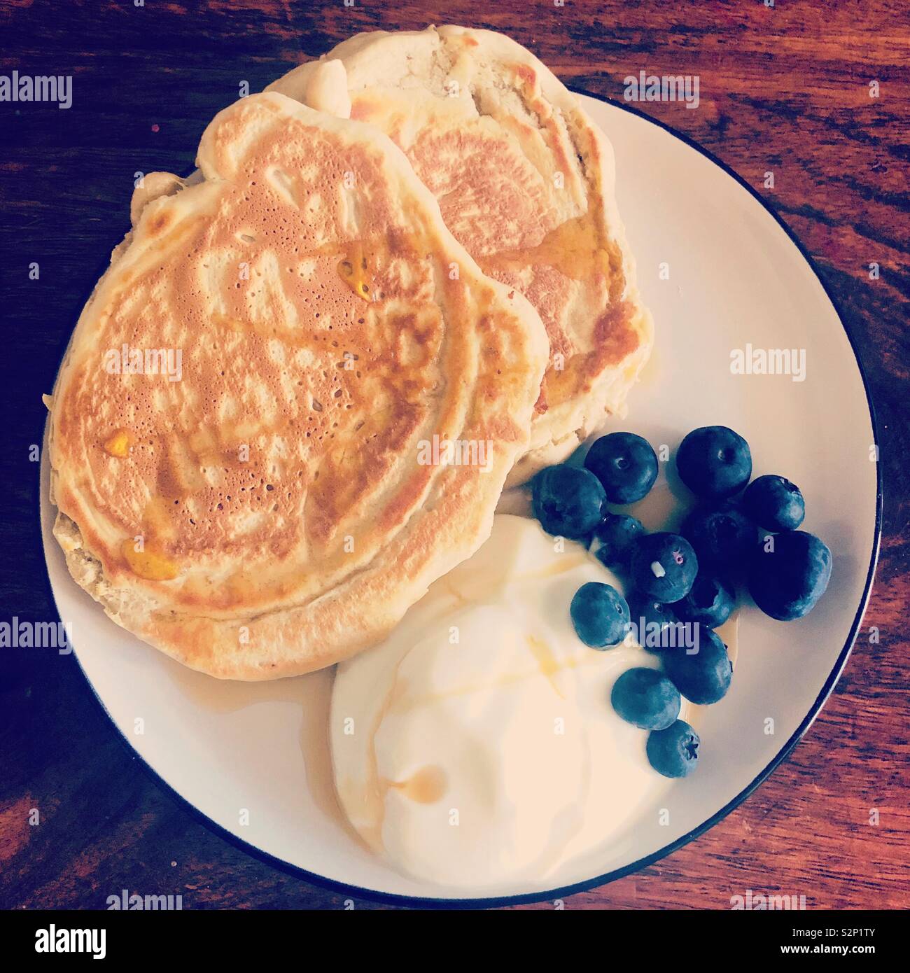 Pancakes blueberries yogurt and syrup breakfast Stock Photo
