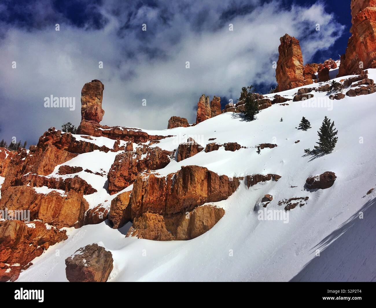 Red Rock desert spires stick out of the deep winter snow in Utah. Stock Photo