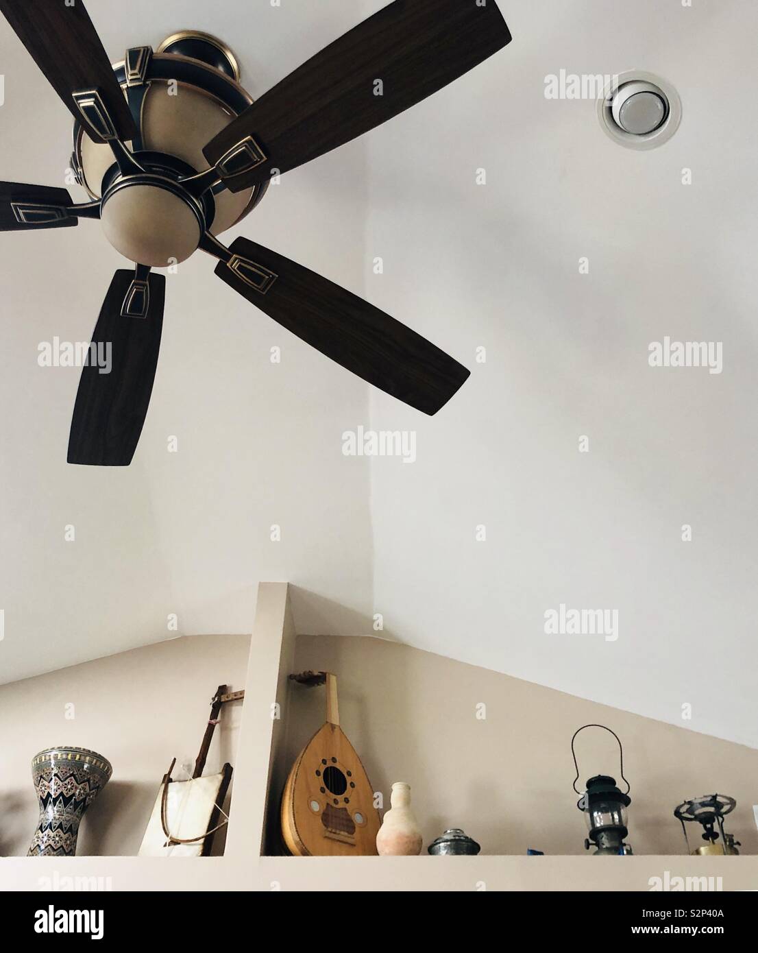 Ceiling Fan On Vaulted Ceiling With A Display Of Middle