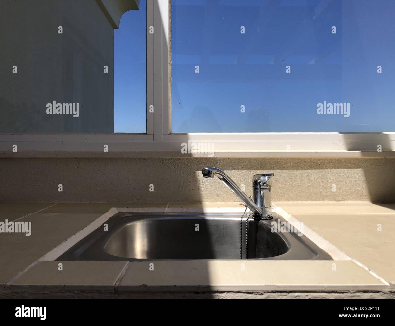Outdoor sink half in sun half in shade Stock Photo