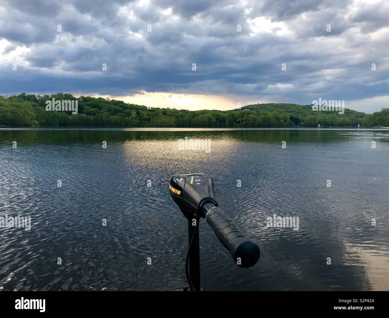 Lake fishing at sunset while a storm breaks Stock Photo