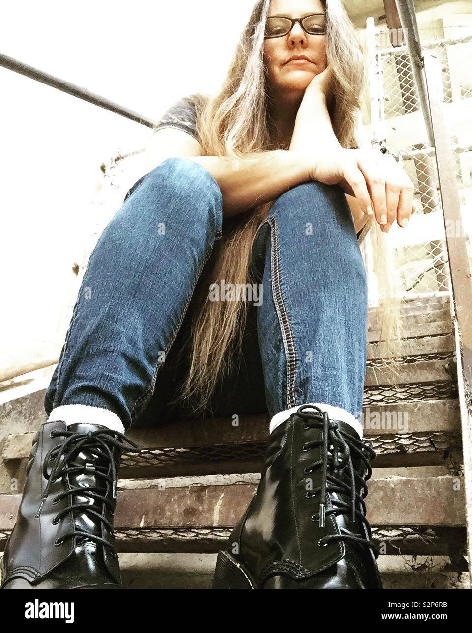 Girl sitting on stairs Stock Photo