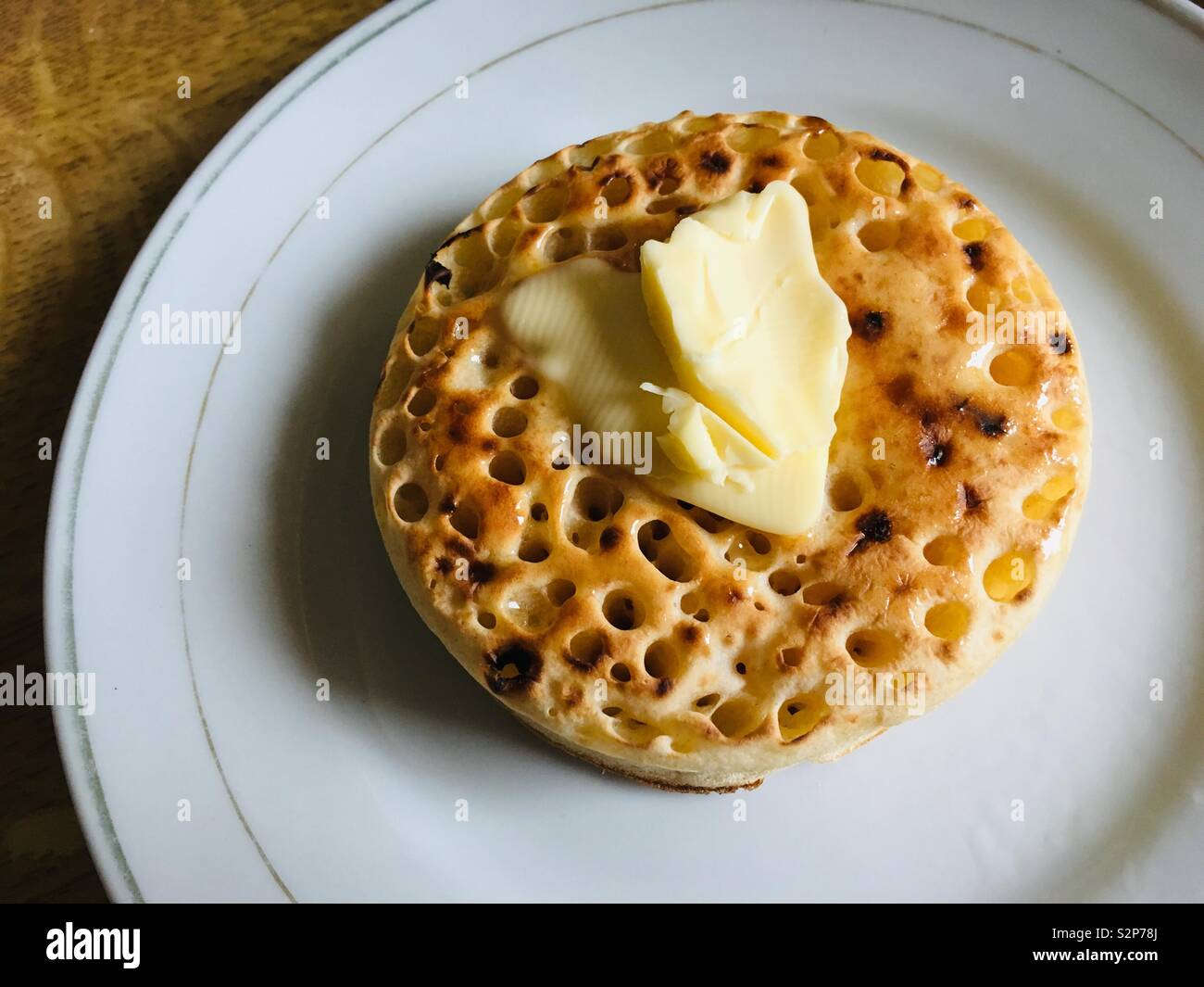 Butter on top of a crumpet Stock Photo
