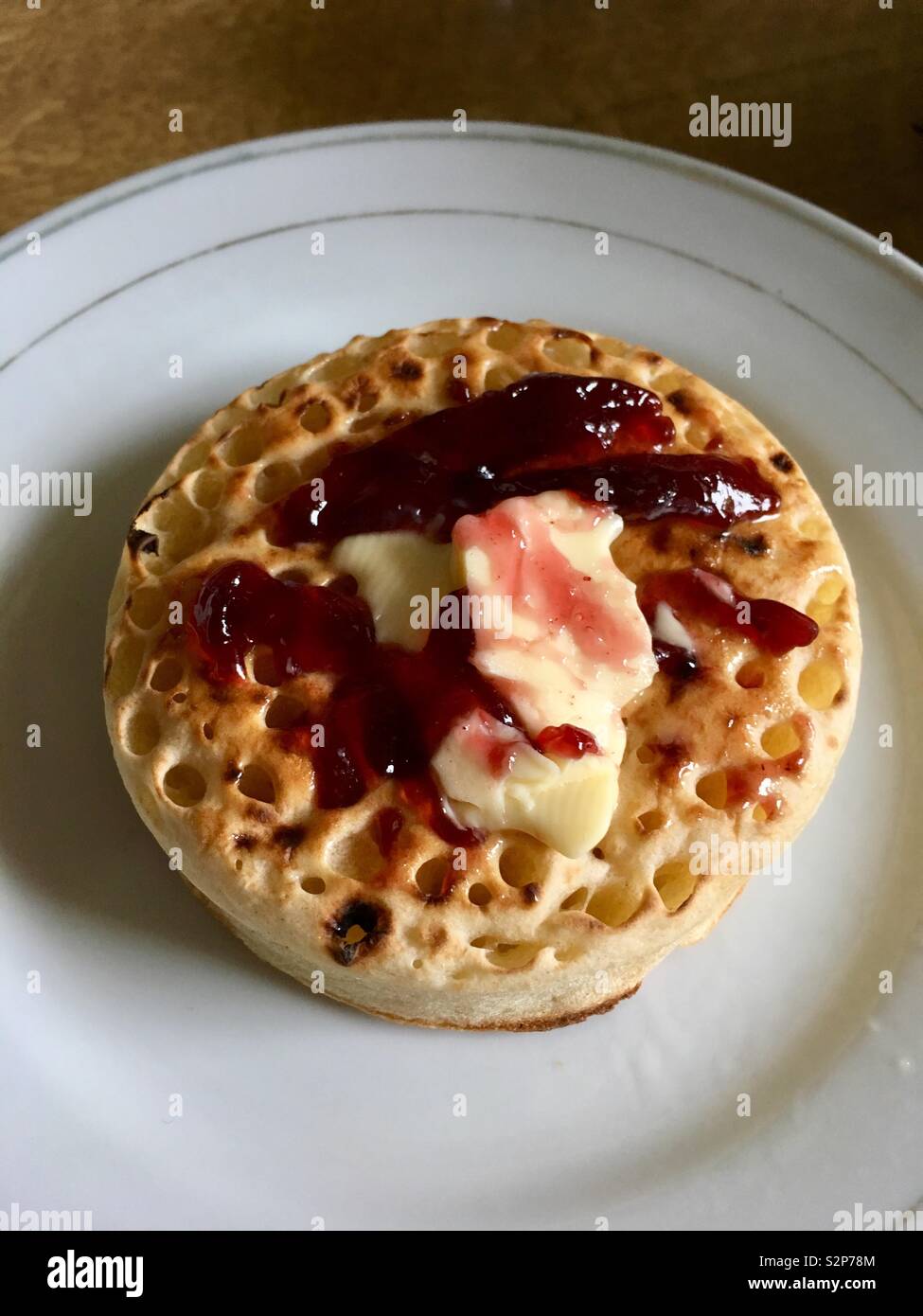 Jam and butter on top of a crumpet Stock Photo