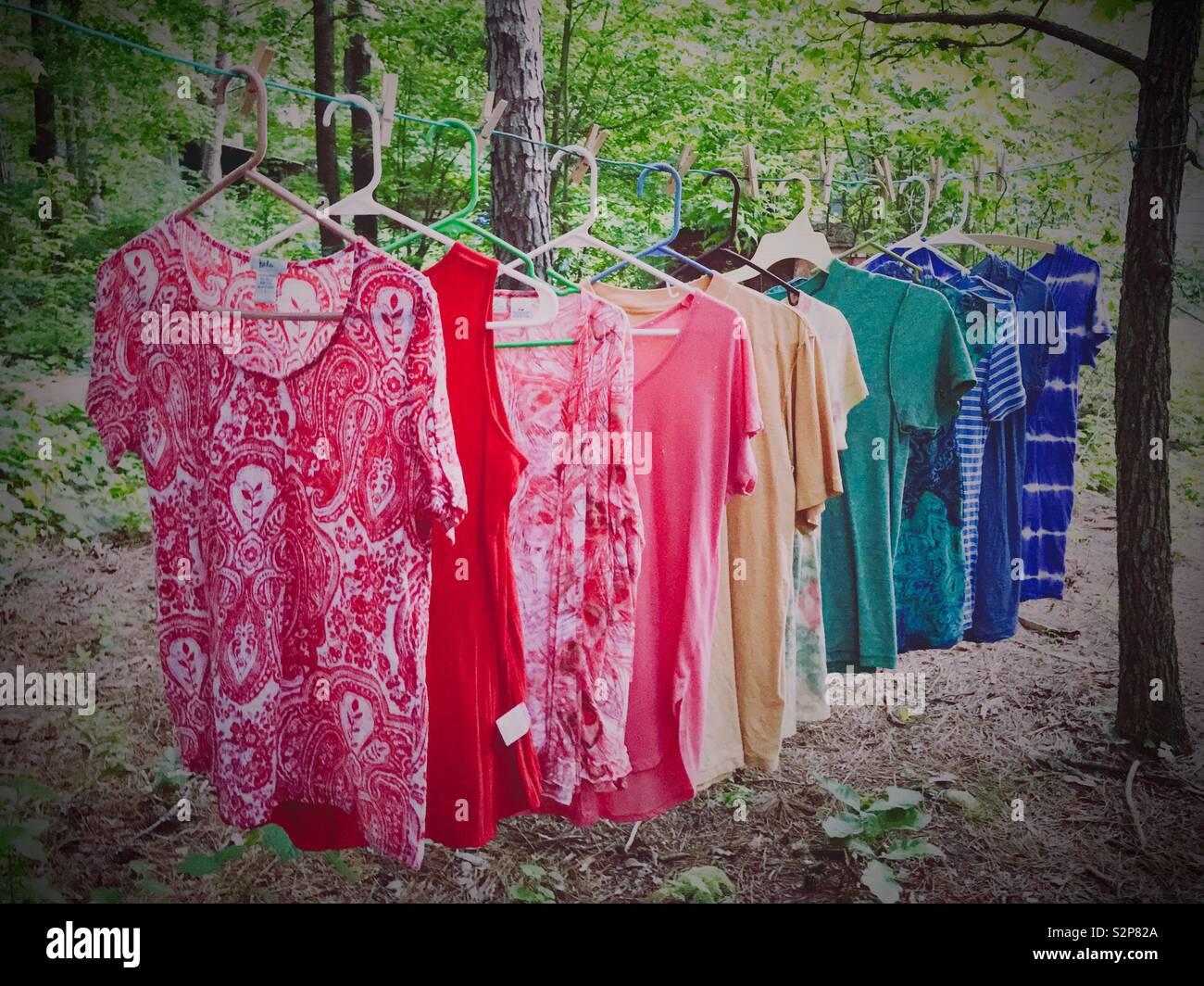 Shirts on hangers hung on a clothesline according to color in the spectrum Stock Photo Alamy