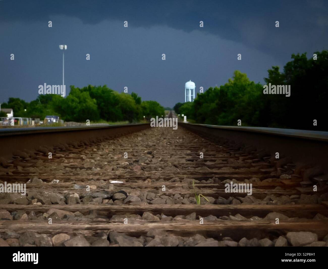 Dark storm clouds hovering down from the railroad track Stock Photo - Alamy