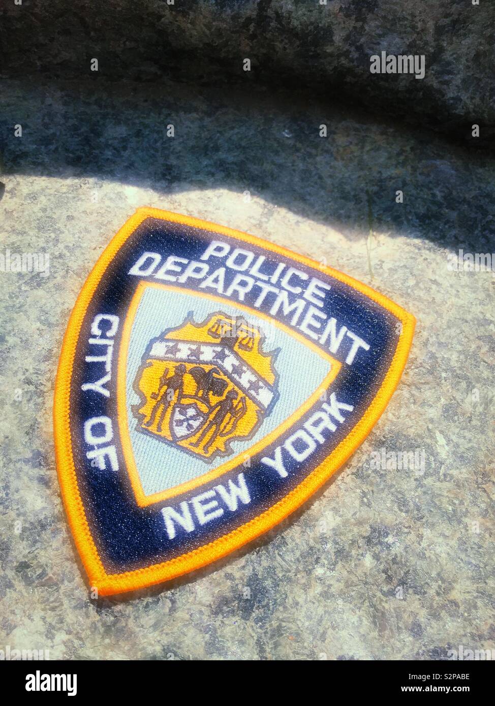 A New York City police department patch at the 9/11 Memorial Glade honoring rescue and recovery personnel, NYC, USA - Smartphone Captured Stock Image