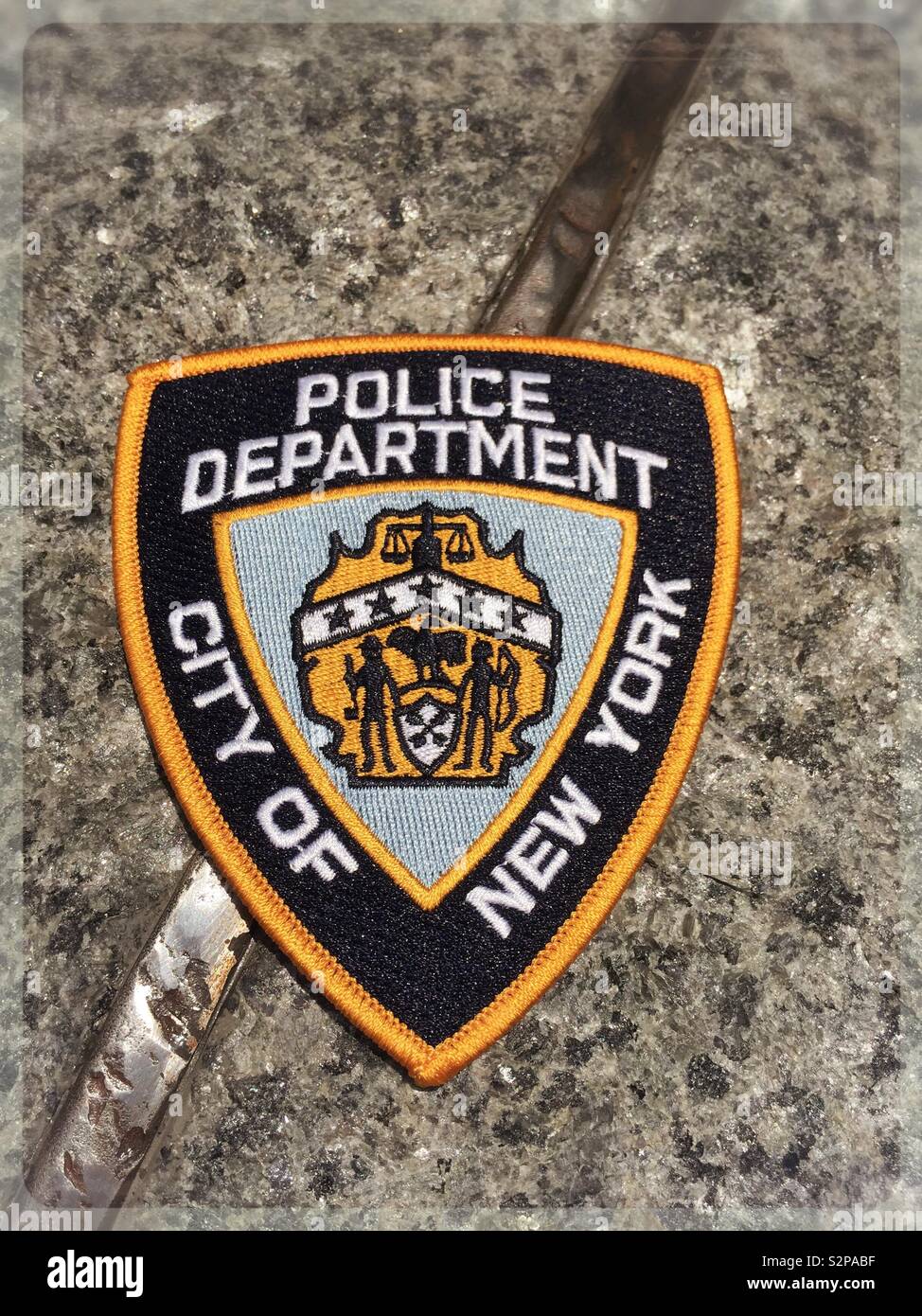 New York City police department patch at the 9/11 Memorial Glade honoring rescue and recovery personnel, NYC, USA - Smartphone Captured Stock Image