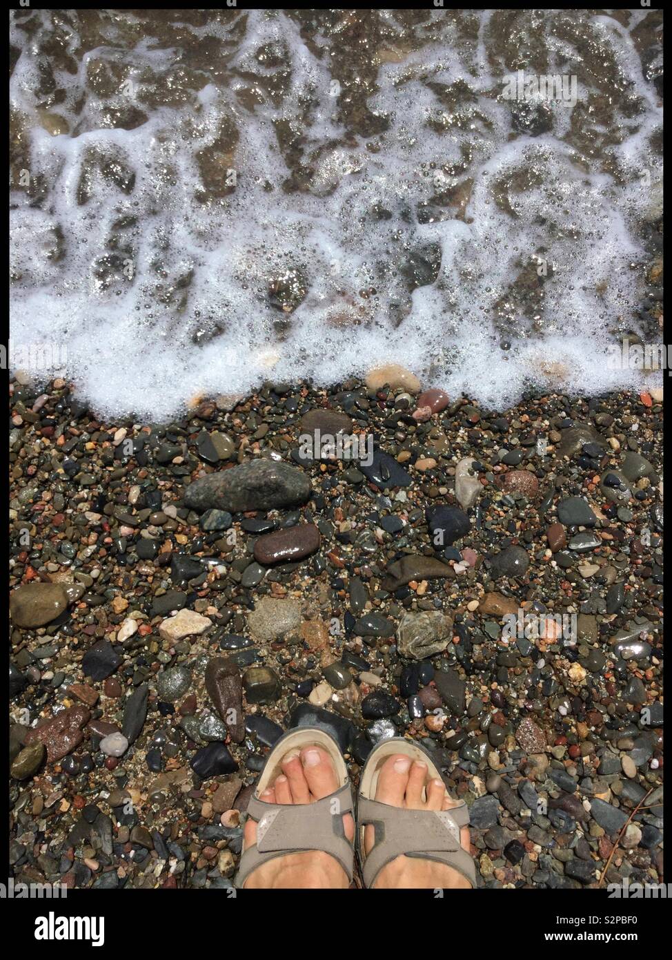 Feet on the beach by the sea at Cambrils, Catalonia, Spain. - Smartphone Captured Stock Image