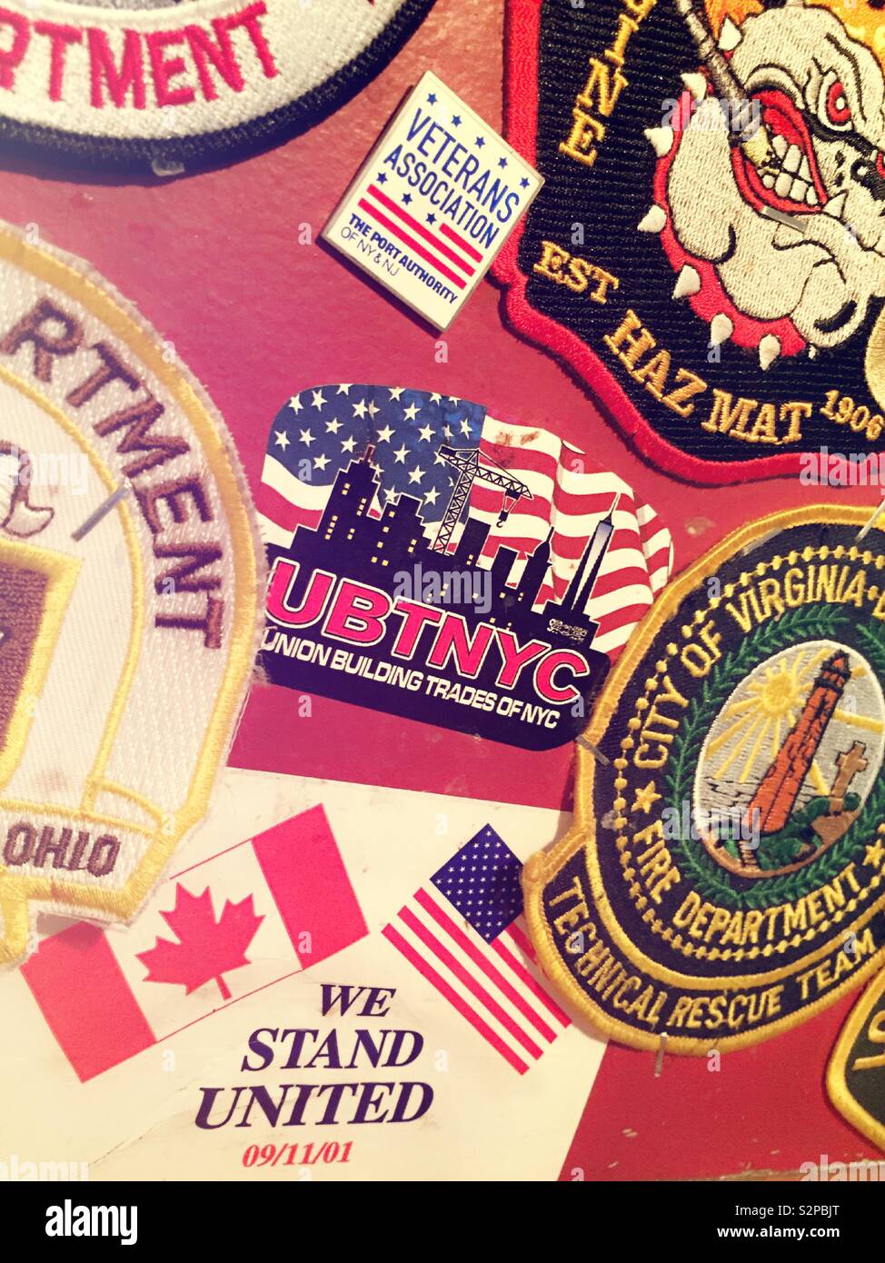 Military and police patches at O’Hara’s Irish pub near the 911 Memorial, NYC, USA - Smartphone Captured Stock Image