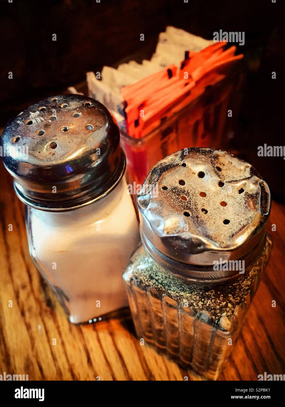 Close up of beat up and battered salt and pepper shakers in a  New York City Irish pub, USA - Smartphone Captured Stock Image