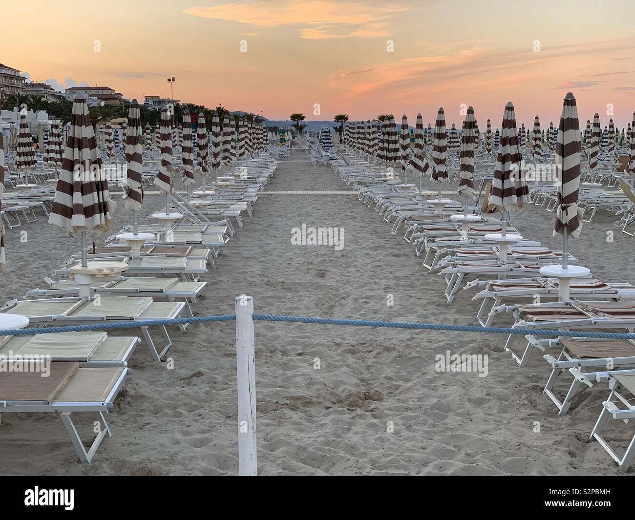 Beach umbrellas and chaise longues view at the end of the day Stock Photo