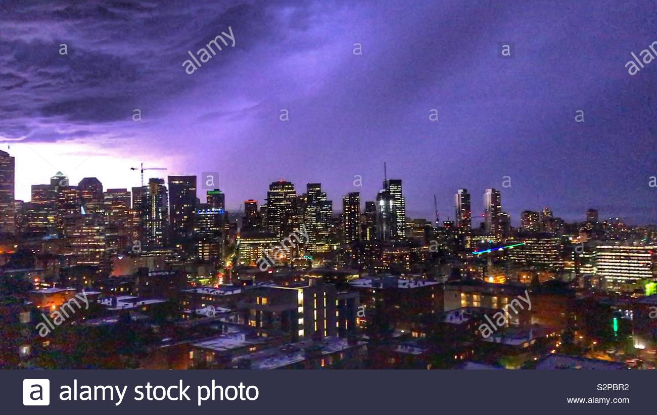 Lightning hitting a building in Seattle Washington. Lighting up the sky and making it purple. Stock Photo