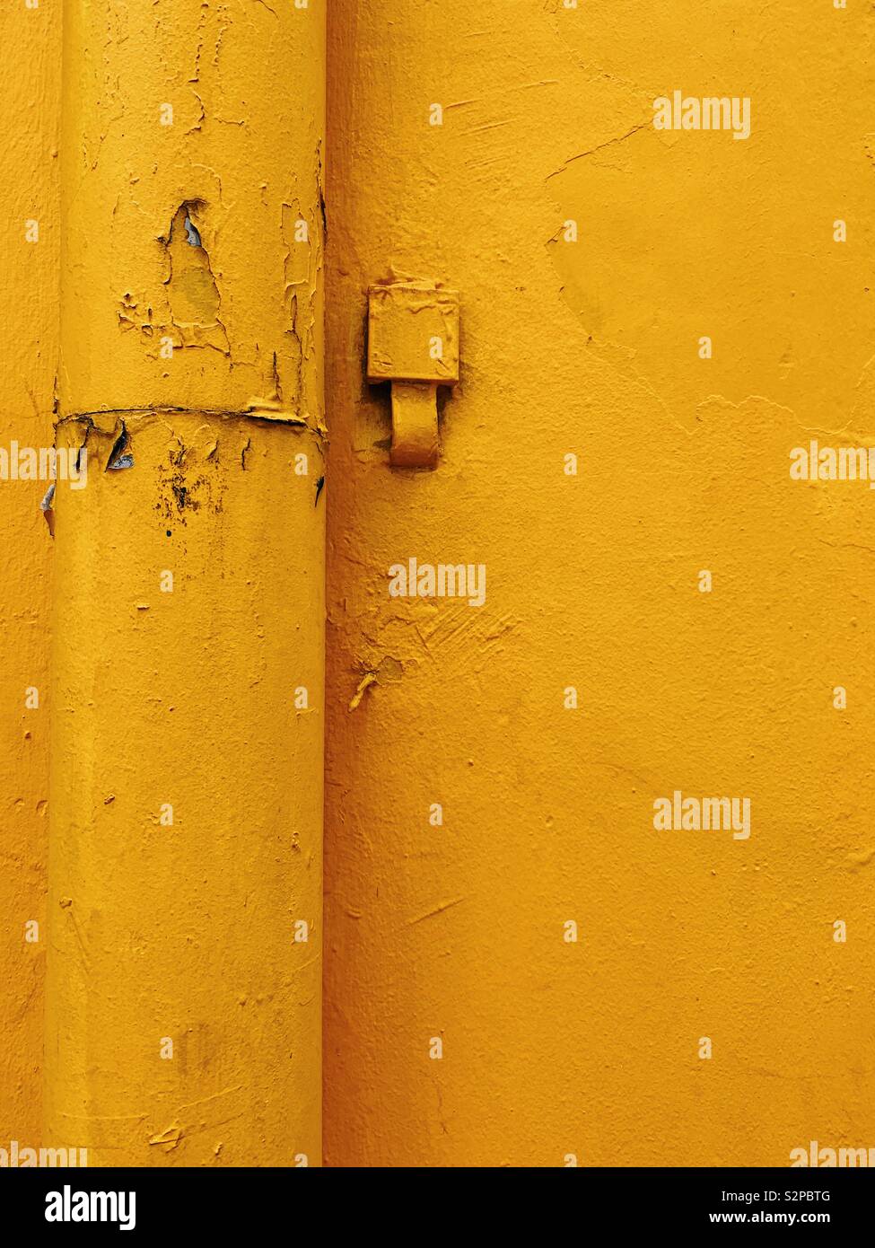 Yellow pipe on yellow wall in Chinatown Singapore - Smartphone Captured Stock Image
