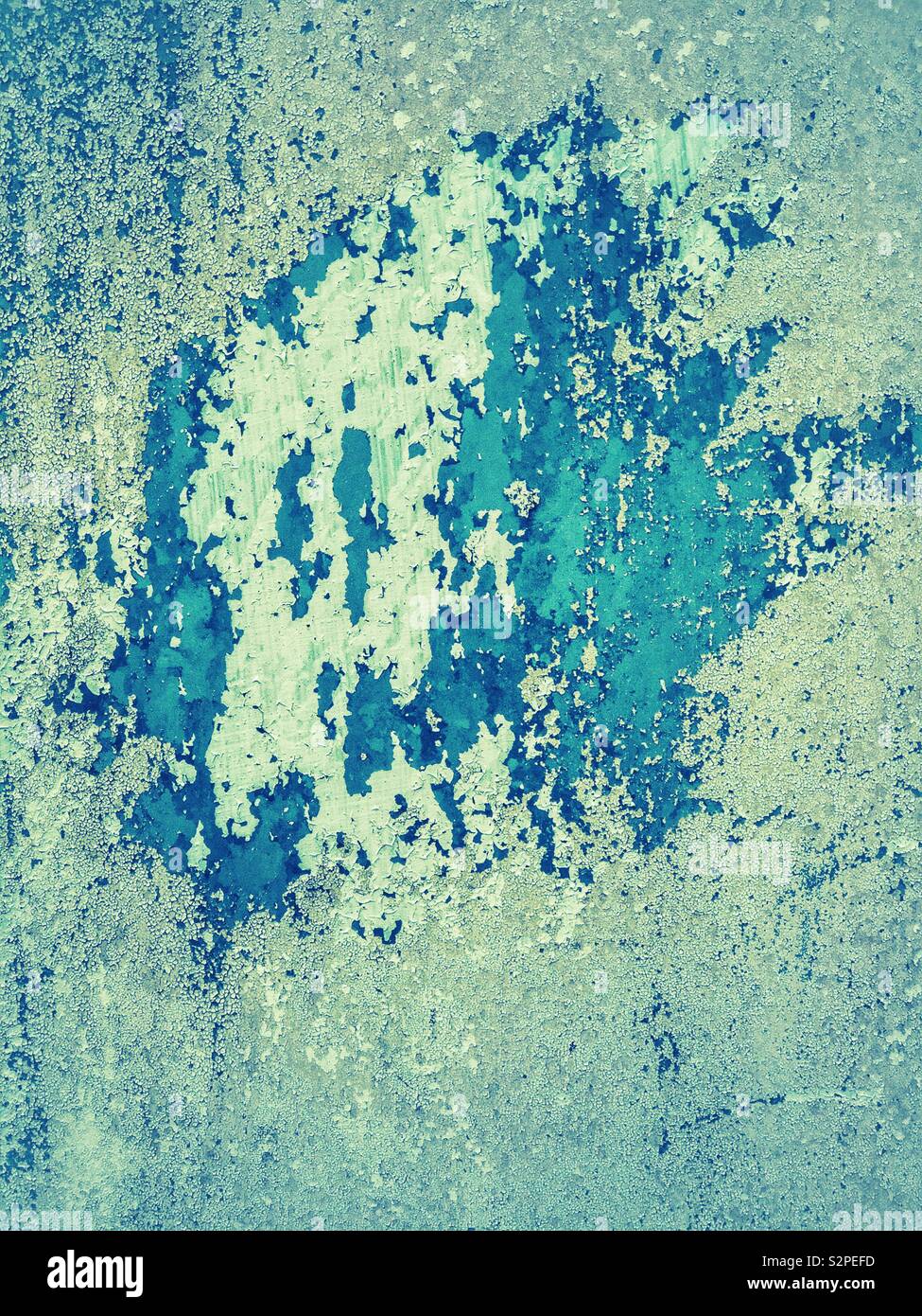 Peeling and decaying paint on a wooden door. Stock Photo