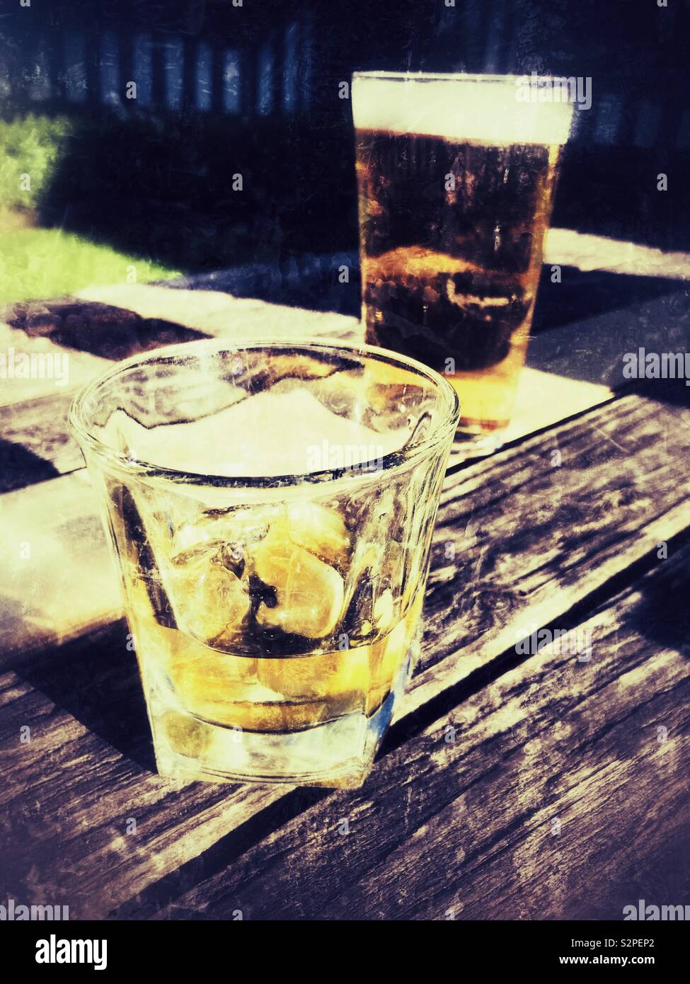 Drinking whisky and beer outdoors, grunge filter applied Stock Photo