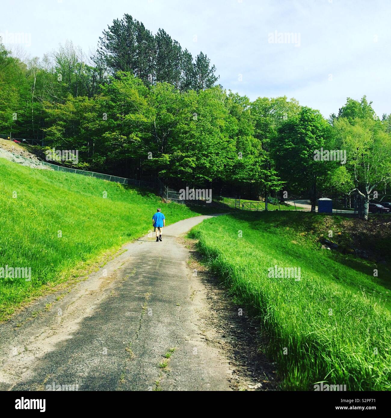 Man walking on a path near Harriman Dam, Whitingham, Vermont, United
